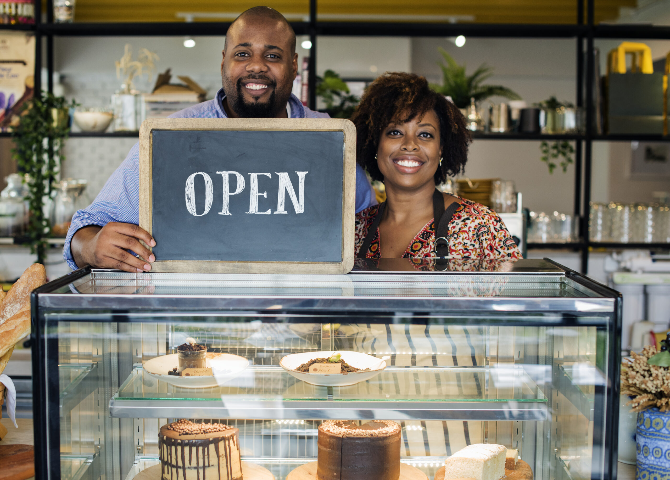 Black couple, husband and wife - small business owners in bakery